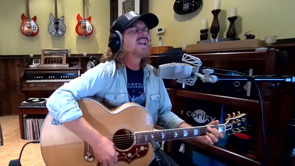 Eddie Vedder performing with an acoustic guitar during his Howard Stern Show appearance