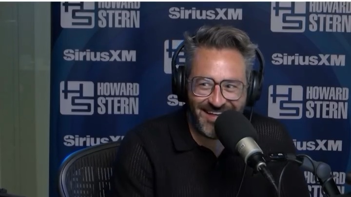 Eliot Glazer speaking into a microphone during the Howard Stern Wrap Up Show